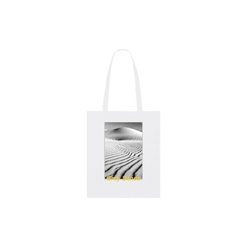 The STAU773 Stanley/Stella Organic Cotton Light Woven Tote Bag features a black and white rippled sand dunes image with the text "Grey Sands" in vibrant yellow.