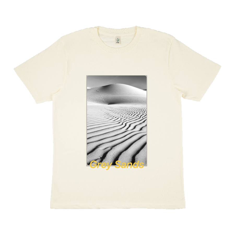 The Continental Clothing EP01 Earth Positive Mens Unisex Classic Jersey T-Shirt in Ecru features a black and white photo of sand dunes with ripples and is labeled "Grey Sands" in yellow text.