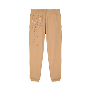 The STBU185 Stella/Stella Mover 2.0 Iconic Unisex Jogger Pants by Stanley/Stella are tan with a drawstring waist, crafted from brushed fleece, and feature star and crescent moon designs for supreme comfort and style.